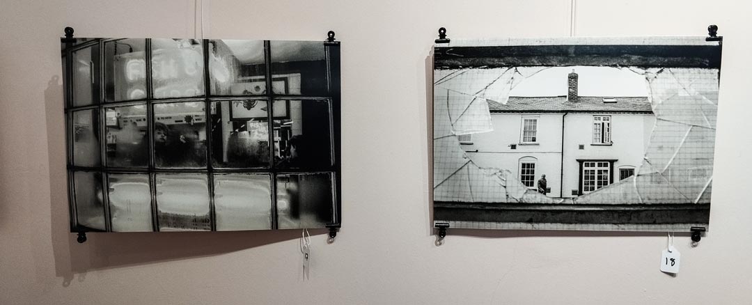 Two black and white photographic prints on a gallery wall taken in the 1980s in Leominster, Herefordshire.